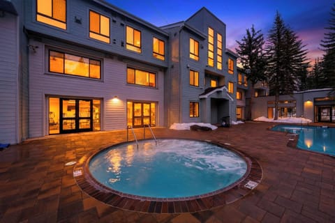 Relax in the bubbling communal spa at dusk, just steps from the community pool and fitness center—mountain evenings done right.
