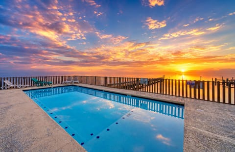 Sunrise swims at the shared waterfront pool—pure coastal calm.
