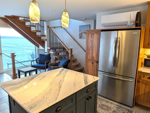 KITCHEN (MAIN FLOOR):  The home has a new and modern kitchen with all appliances including a dishwasher.  Also includes a coffee bar, kitchen island, and bar stools.