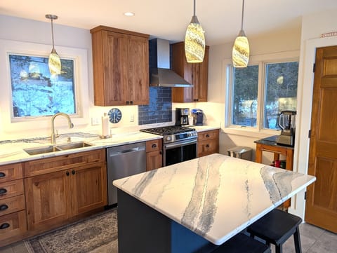 KITCHEN (MAIN FLOOR):  The home has a new and modern kitchen with all appliances including a dishwasher.  Also includes a coffee bar, kitchen island, and bar stools.