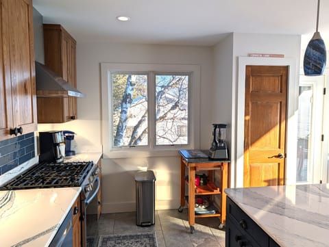 KITCHEN (MAIN FLOOR):  The home has a new and modern kitchen with all appliances including a dishwasher.  Also includes a coffee bar, kitchen island, and bar stools.