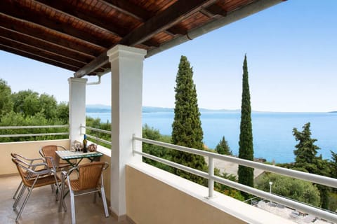Enjoy peaceful mornings and relaxing evenings on the balcony overlooking lush greenery and the sparkling Ionian Sea.