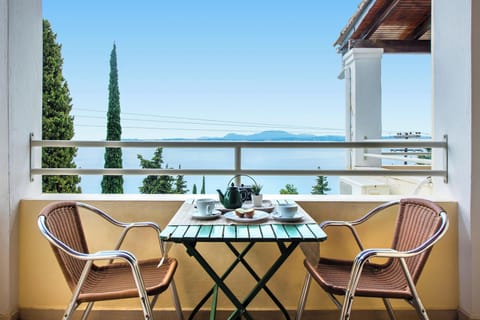Private balcony with outdoor dining table and breathtaking views of the Ionian Sea. A perfect place to enjoy breakfast, coffee, or sunset drinks while overlooking the peaceful Barbati coastline.