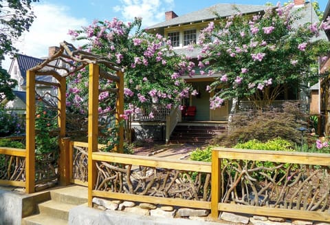 Front view of the cottage. Fenced in front yard and large shaded porch. 