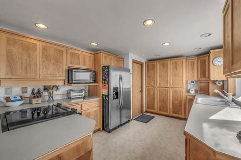 Your spacious kitchen offers everything for home cooking with warm wood cabinets, full appliances, and plenty of prep space.