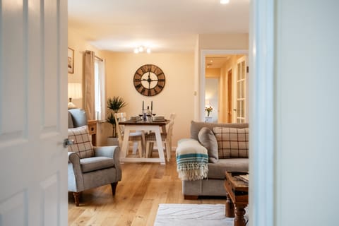 The stylish open-plan sitting and dining room is at the heart of the cottage