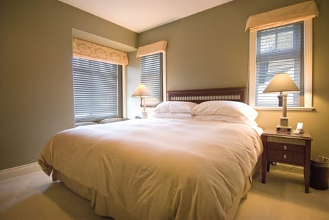 Junior Suite king bed with 3 garden view windows