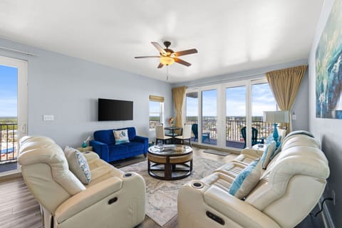 Lakefront Living Area with Flat Screen TV and Private Balcony Access