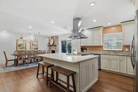 Cook together in your spacious kitchen with granite counters, stainless appliances, and island seating before gathering for meals in the elegant dining area.