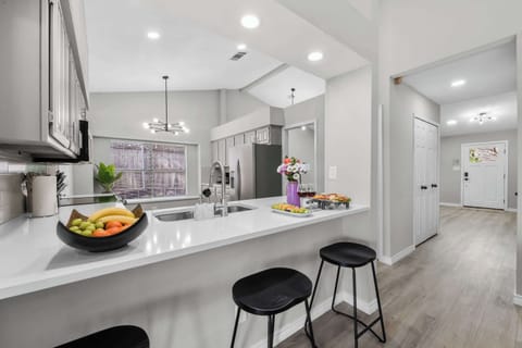 The kitchen bar with additional seating makes it easy to serve breakfast, enjoy morning coffee, or keep the conversation flowing while meals are prepared.