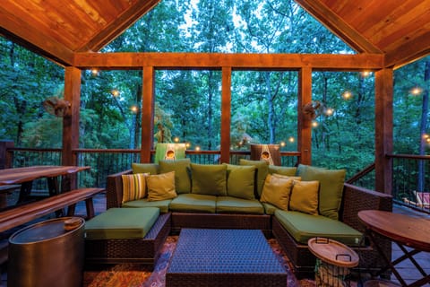Expansive covered deck with woodland views for relaxing and unwinding.