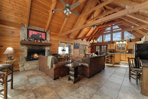 Cozy living space with cable TV, a wood-burning fireplace, a sleeper sofa, and plush furniture