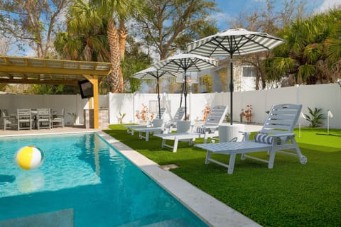 Poolside loungers and umbrellas create the perfect spot to unwind after a morning at the beach.