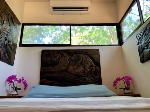 Hand-carved artisan bedroom with jungle views