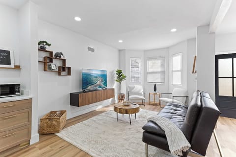 Inviting living space featuring comfortable seating, natural light, and a sofa bed for added flexibility. Perfect for relaxing, streaming your favorite shows, or accommodating extra guests.