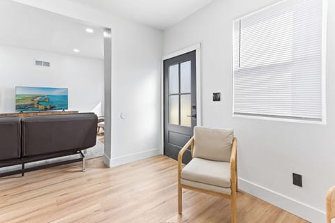 Comfortable living area with clean modern design and warm natural light. A calm and inviting space for reading, relaxing, or unwinding after a busy day.