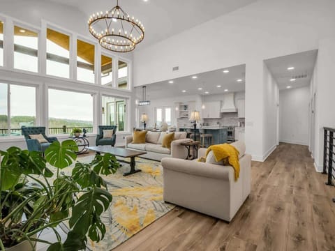 This elegant living room features stunning windows, plush seating, and a warm, welcoming atmosphere. Share laughter, sunset views, and cozy evenings together in the heart of North Carolina.