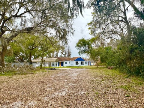 This charming teal lakeside ranch-style home blends vibrant character with laid-back waterfront living, offering the perfect backdrop for relaxing days by the water.