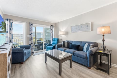 Spacious Living room with seating for everyone and balcony access