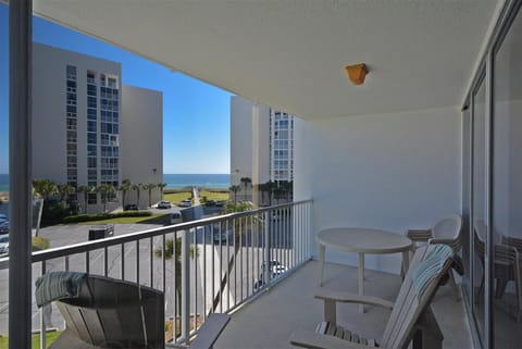 Relax on your private balcony with ocean glimpses between coastal towers, perfect for morning coffee or sunset cocktails.