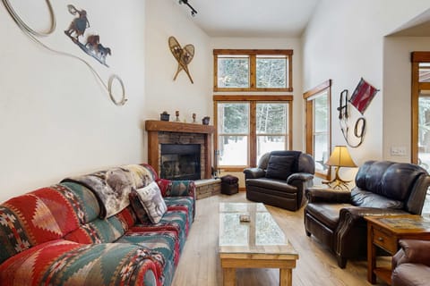 Living room with vaulted ceiling and tall windows