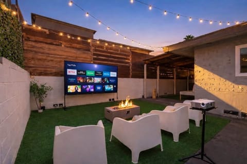 Covered patio with projector screen for outdoor movie nights.