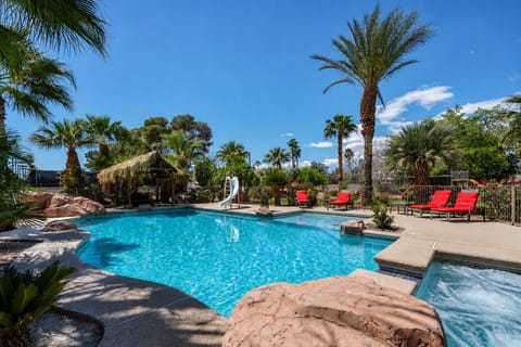 Kids can enjoy the slide, adults can unwind in the spa, and everyone gets to soak up the tropical backyard vibe.