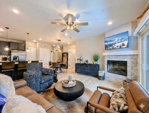 Sink into plush leather seating by the stone fireplace while mountain views dance on the big screen TV above your cozy retreat.