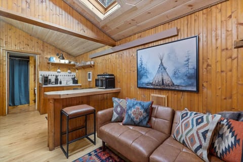 Relax and refuel at Black Hills Bungalows with a welcoming seating area and compact kitchen space, perfectly suited for breaks between Black Hills adventures.