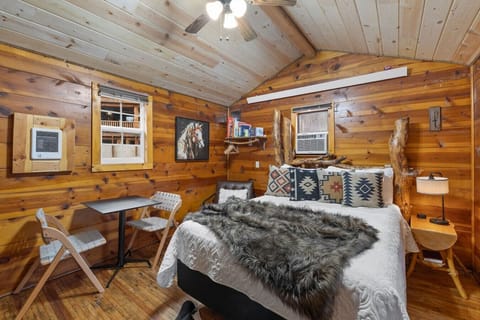 Warm and charming retreat showcasing rustic wood walls, classic western artwork, and a serene cabin ambiance.