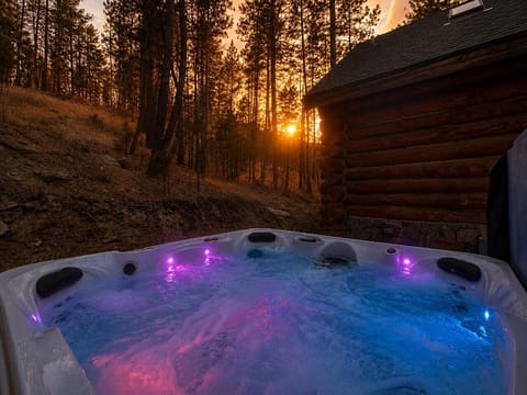 Relax in your private hot tub with color-changing lights surrounded by pine trees. A favorite highlight of this Black Hills cabin retreat.