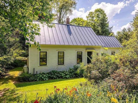 Standing-seam metal roof and perennial gardens in summer