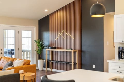 Bright modern living space with slat wall art and patio access