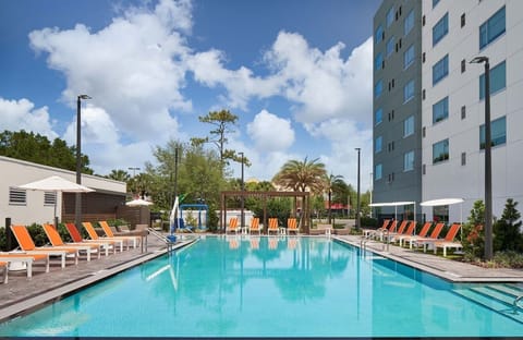 Dive into sparkling turquoise waters surrounded by chic loungers.