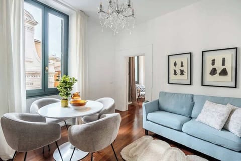 Bright lounge with chandelier, hardwood floors, and historic views.
