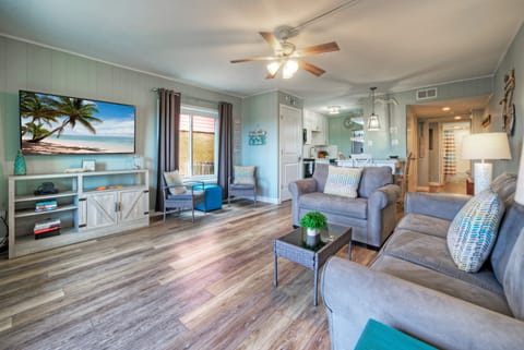Coastal-inspired living with soothing seafoam walls, plush seating, and an open layout perfect for relaxing after a day at the beach.