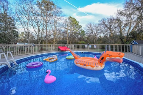 A sleek, geometrically shaped pool, adorned with clean lines and sophisticated features, defines this modern masterpiece. The pool's minimalist design is complemented by elegant water features, such as cascading water walls or fountains that add a calming ambiance. 