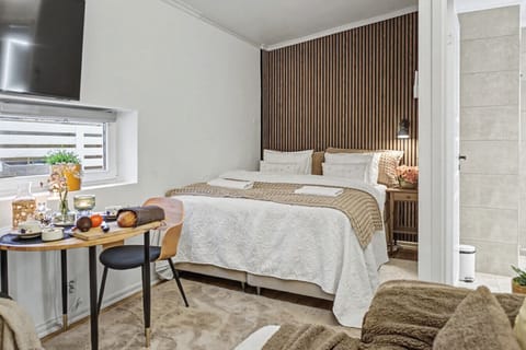 Comfortable king bed with dining area and easy access to a modern bathroom