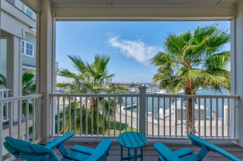 Sip your morning coffee on this tropical balcony overlooking swaying palms and marina views.