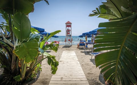 Private beach, white sand, sun loungers, beach umbrellas