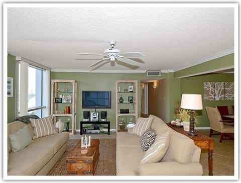 Relax in your stylish living room with comfortable seating, entertainment center, and soothing green walls that create the perfect retreat.