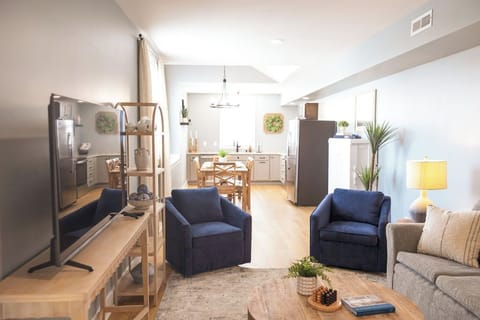 This loft has an open concept kitchen, dining, and living area.