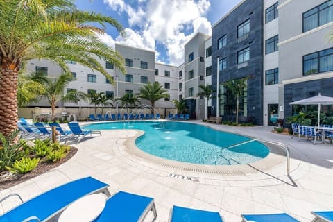 Dive into refreshing waters or lounge in the sunshine by the inviting swimming pool surrounded by lush greenery.