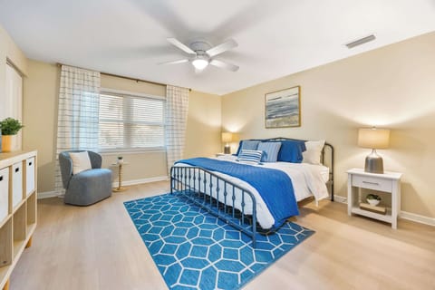 Bright bedroom with a metal bed frame and blue accents for a relaxing stay