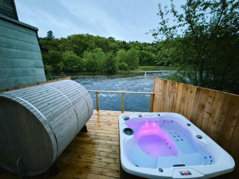 Waterfront with hot tub and cedar barrel sauna