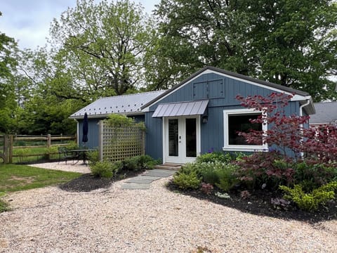 Exterior of cottage with stone patio & gardens