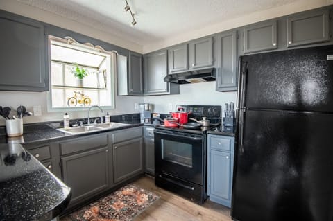 Enjoy Unit A's full kitchen, complete with everything you can think of (even a water filter pitcher in the fridge!)