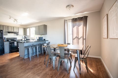 Unit F's dining space has plenty of seating with 6 chairs total and 4 bar seats. Great for a group card game or family meal together!