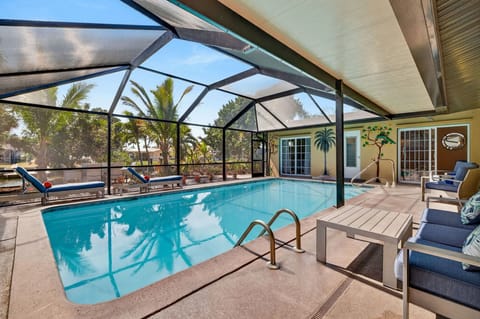 Sunny private pool at Coral Palm Retreat showcases a spacious backyard retreat ideal for swimming, lounging, and soaking up the Florida sunshine.