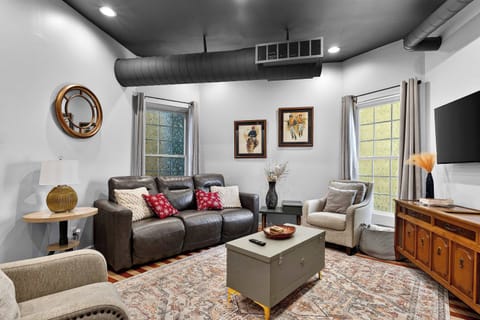 Living Area: A bright and cozy living room with comfortable seating and a relaxing atmosphere.